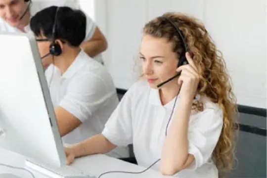 A contact center operator is asking several questions and turning the line to a logistics dispatcher scheduling the service engineers